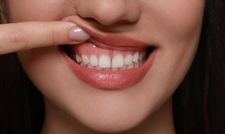 Person following night oral care routine by brushing teeth before sleep